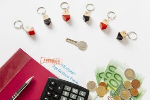 key-with-house-figurines-papers